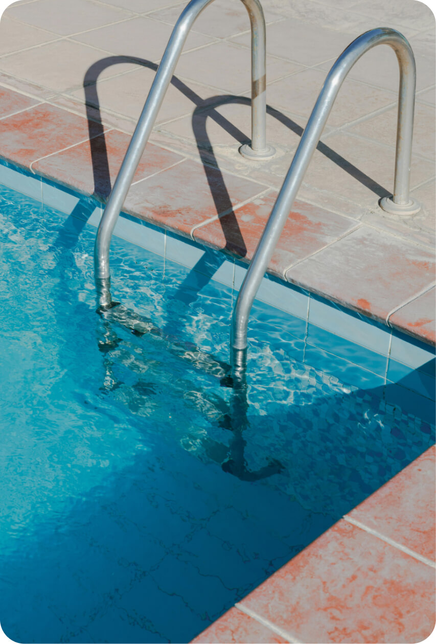 Empty swimming pool with a ladder