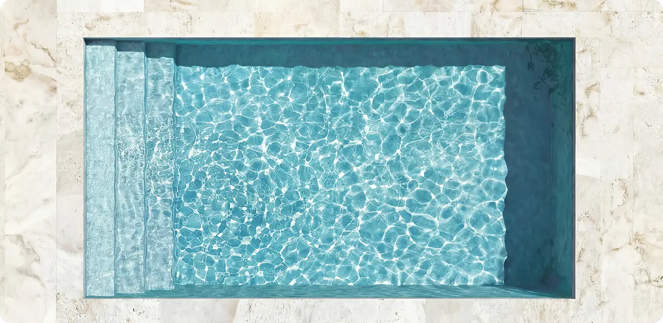 Swim jet beside stone pool decking